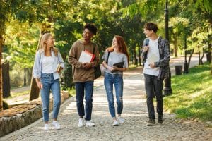 group of happy students walking at the campus